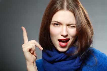 Smiling beautiful woman having an idea close up face pointing up with finger